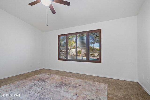 unfurnished room with ceiling fan and vaulted ceiling