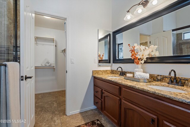 bathroom with vanity, tile patterned flooring, and walk in shower