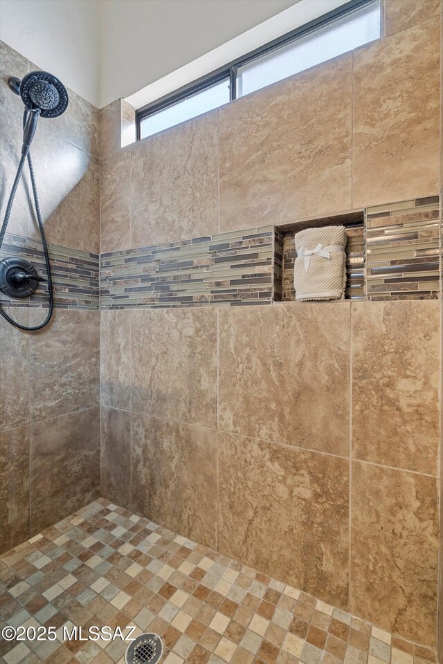 bathroom with tiled shower