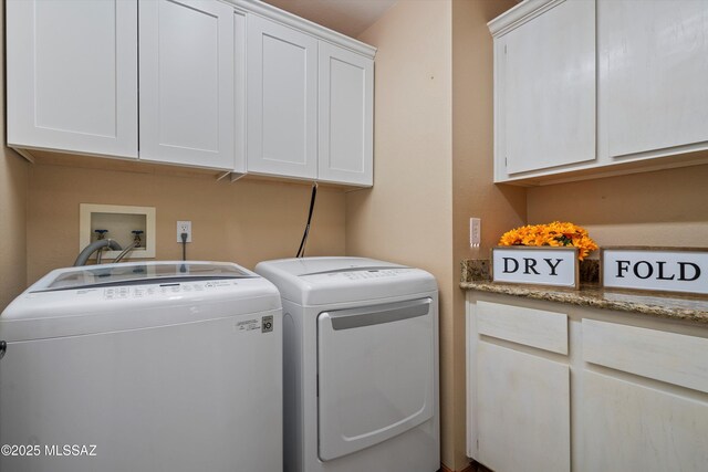 laundry room with cabinets and washer and dryer