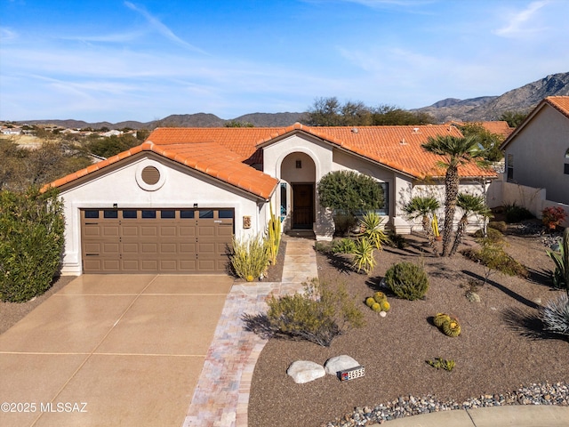 mediterranean / spanish-style house featuring a mountain view and a garage