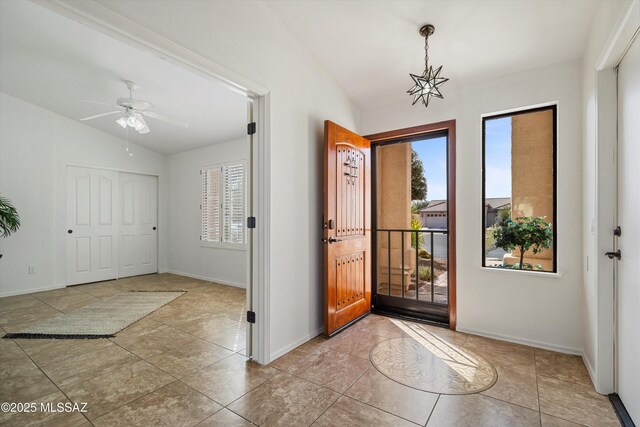 entrance foyer with lofted ceiling and ceiling fan