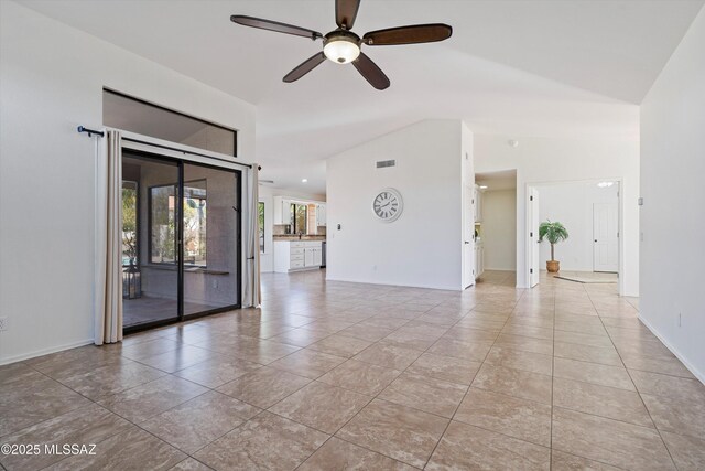 tiled spare room featuring ceiling fan and high vaulted ceiling