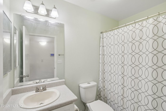 bathroom with a shower with curtain, vanity, and toilet