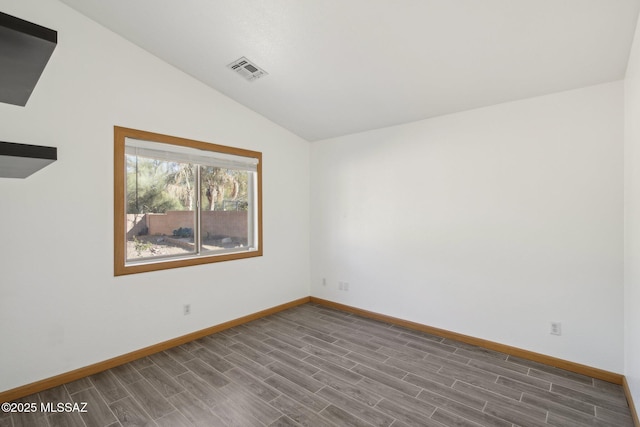 unfurnished room featuring lofted ceiling and hardwood / wood-style flooring