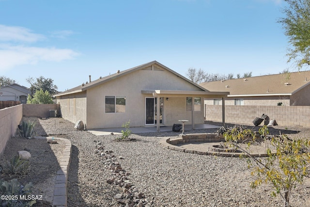 back of property with cooling unit and a patio