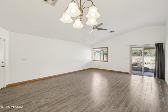 spare room with vaulted ceiling, dark wood-type flooring, and ceiling fan with notable chandelier