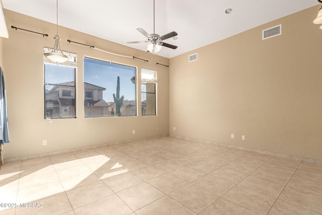 tiled empty room featuring ceiling fan