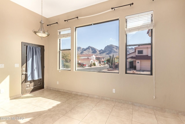 empty room featuring light tile patterned flooring and a mountain view