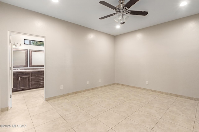 unfurnished room featuring ceiling fan and light tile patterned floors