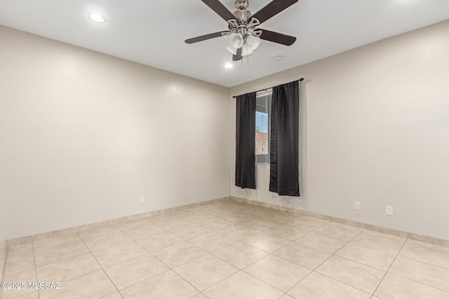 tiled spare room with ceiling fan