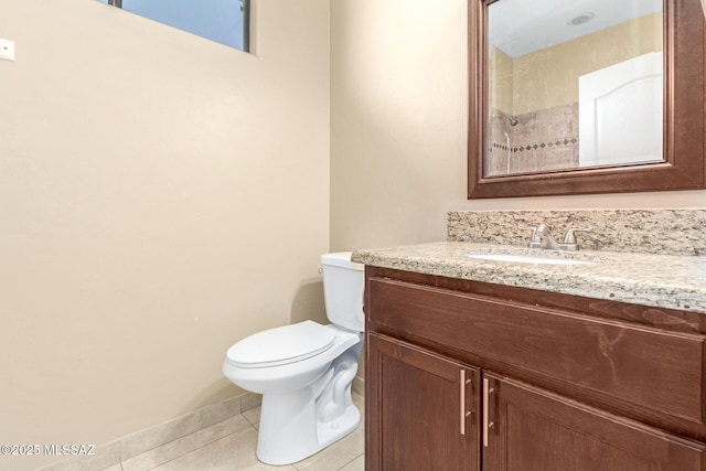 bathroom featuring toilet, tile patterned flooring, and vanity