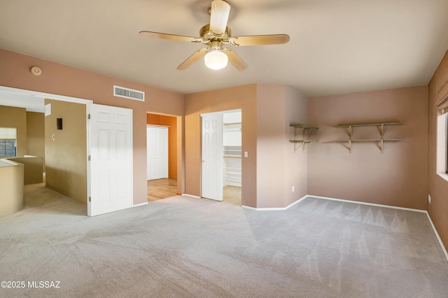 unfurnished bedroom featuring ceiling fan and light carpet