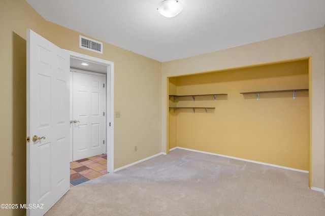 unfurnished bedroom featuring carpet floors and a closet