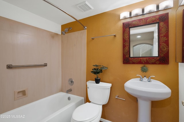 bathroom featuring bathtub / shower combination and toilet