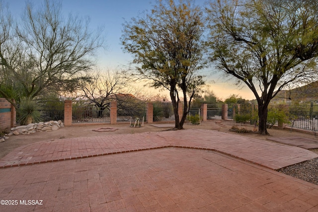 yard at dusk with a patio area