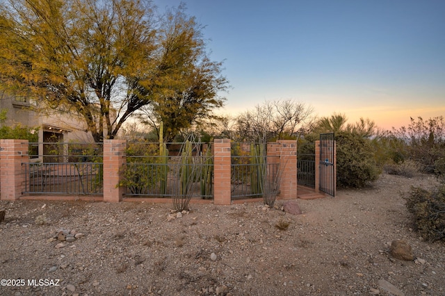 view of gate at dusk