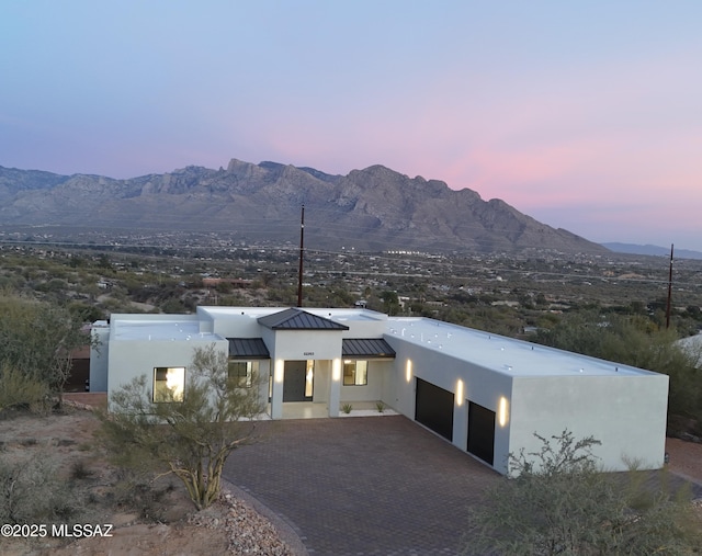 view of front of house featuring a garage and a mountain view