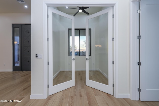 interior space featuring hardwood / wood-style flooring, ceiling fan, and french doors