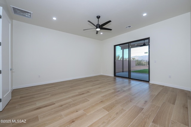 spare room featuring light wood-type flooring and ceiling fan