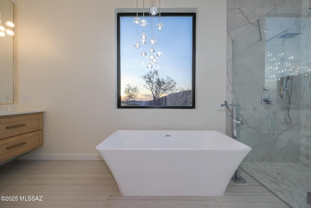 bathroom featuring vanity and independent shower and bath