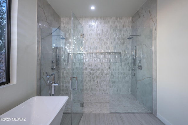 bathroom with separate shower and tub