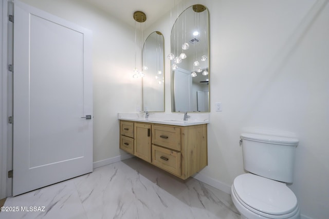 bathroom featuring toilet and vanity