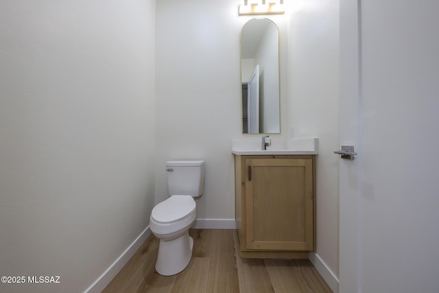 bathroom featuring vanity, toilet, and wood-type flooring