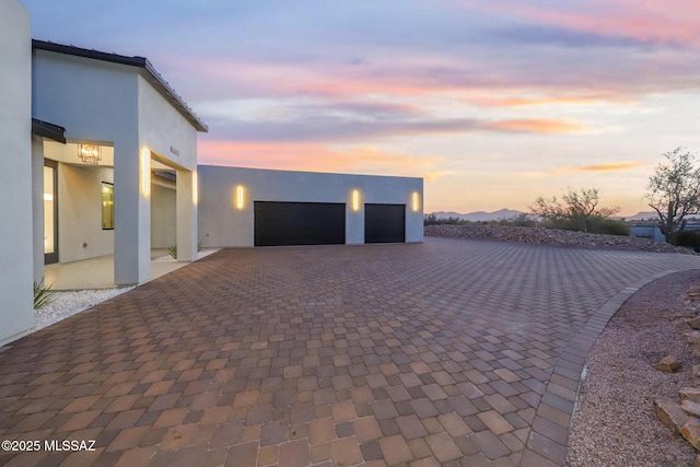 view of garage at dusk