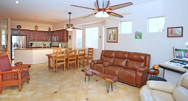 living room with light tile patterned floors and ceiling fan