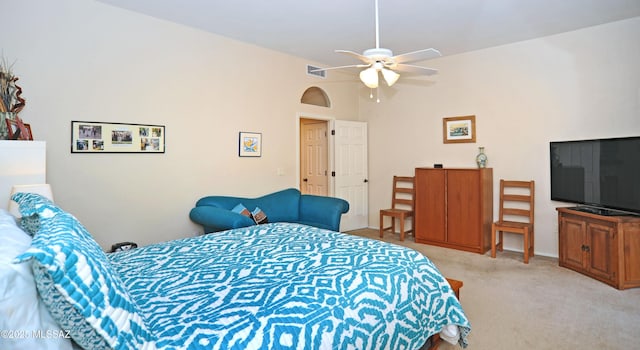 bedroom featuring light carpet, visible vents, ceiling fan, and lofted ceiling