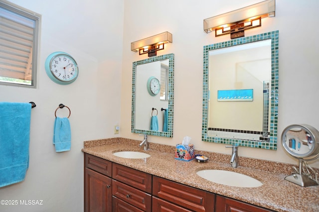 full bathroom with double vanity and a sink