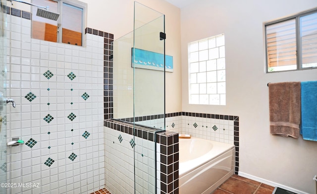 full bath featuring tile patterned floors, a shower stall, baseboards, and a garden tub