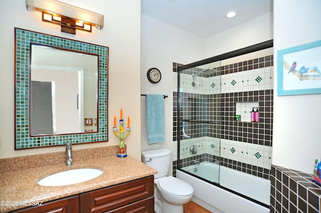 bathroom featuring recessed lighting, shower / bath combination with glass door, vanity, and toilet