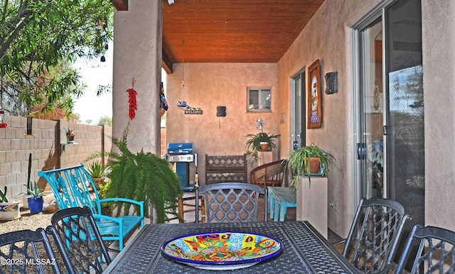 view of patio / terrace with outdoor dining space, fence, and a grill