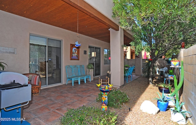 view of patio featuring area for grilling and fence