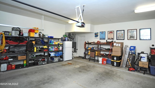 garage featuring a garage door opener and freestanding refrigerator