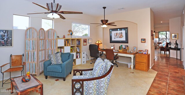 tiled living room with ceiling fan