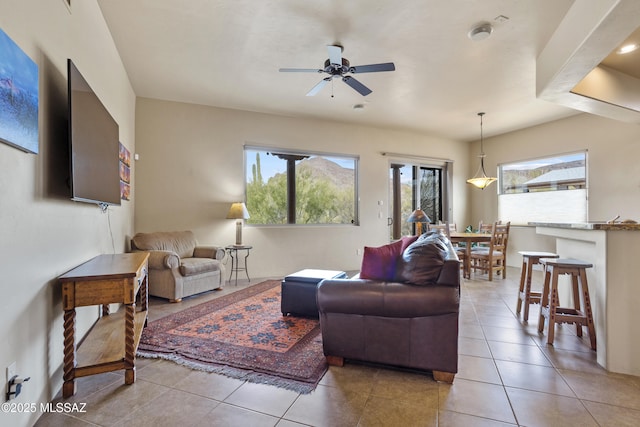 tiled living room featuring ceiling fan