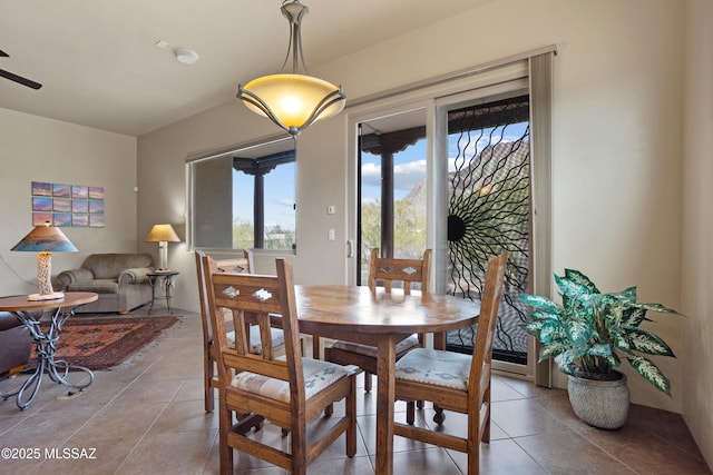 tiled dining space featuring ceiling fan