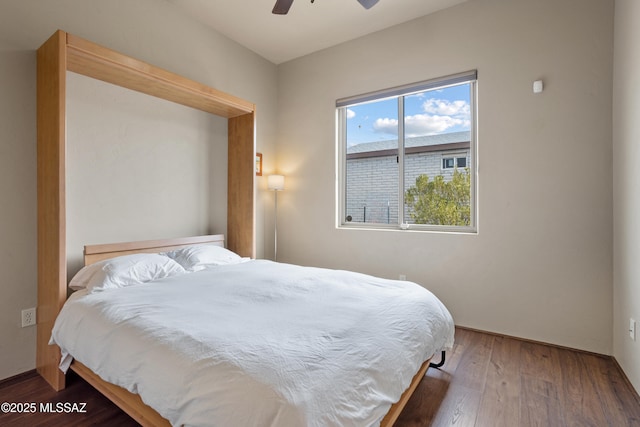 bedroom with a ceiling fan and wood finished floors