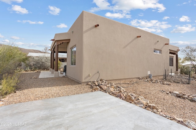view of property exterior with a patio area and stucco siding