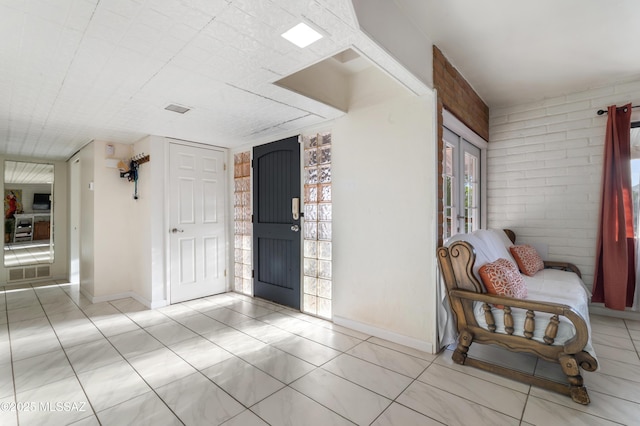 entryway with french doors and brick wall