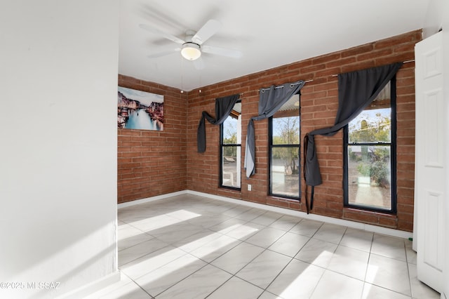 empty room with brick wall and ceiling fan