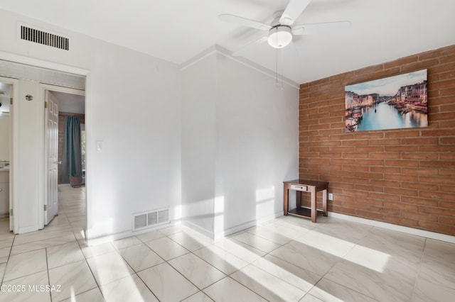 empty room featuring brick wall and ceiling fan