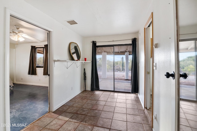 entrance foyer featuring ceiling fan and carpet floors