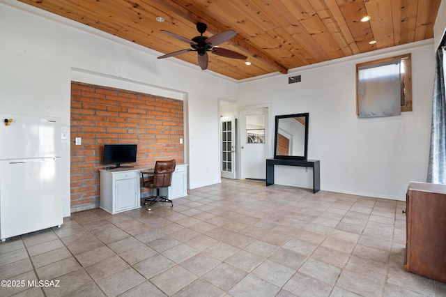 unfurnished office featuring ceiling fan, wooden ceiling, and beamed ceiling