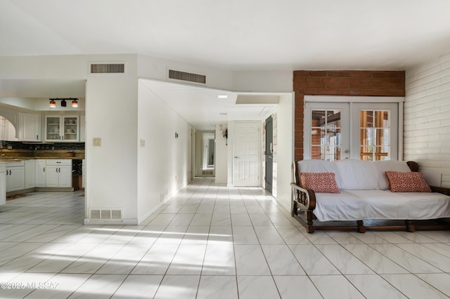 unfurnished living room featuring french doors