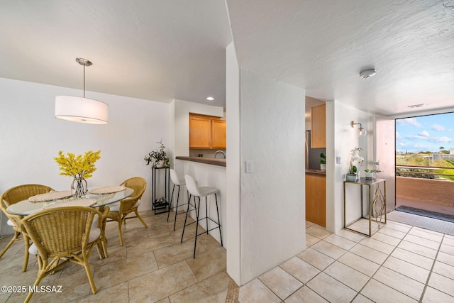 kitchen with a wall of windows and a breakfast bar area