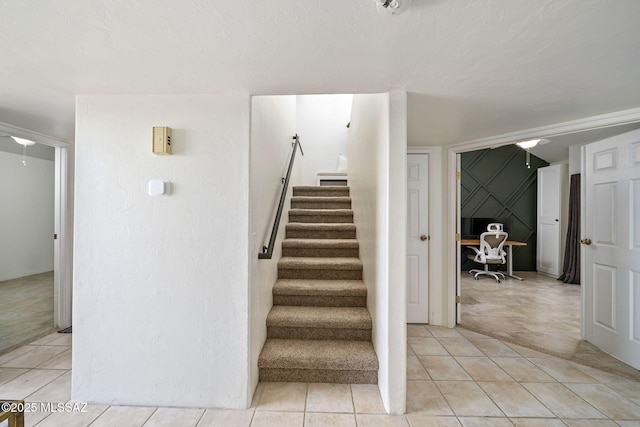 stairway with tile patterned floors